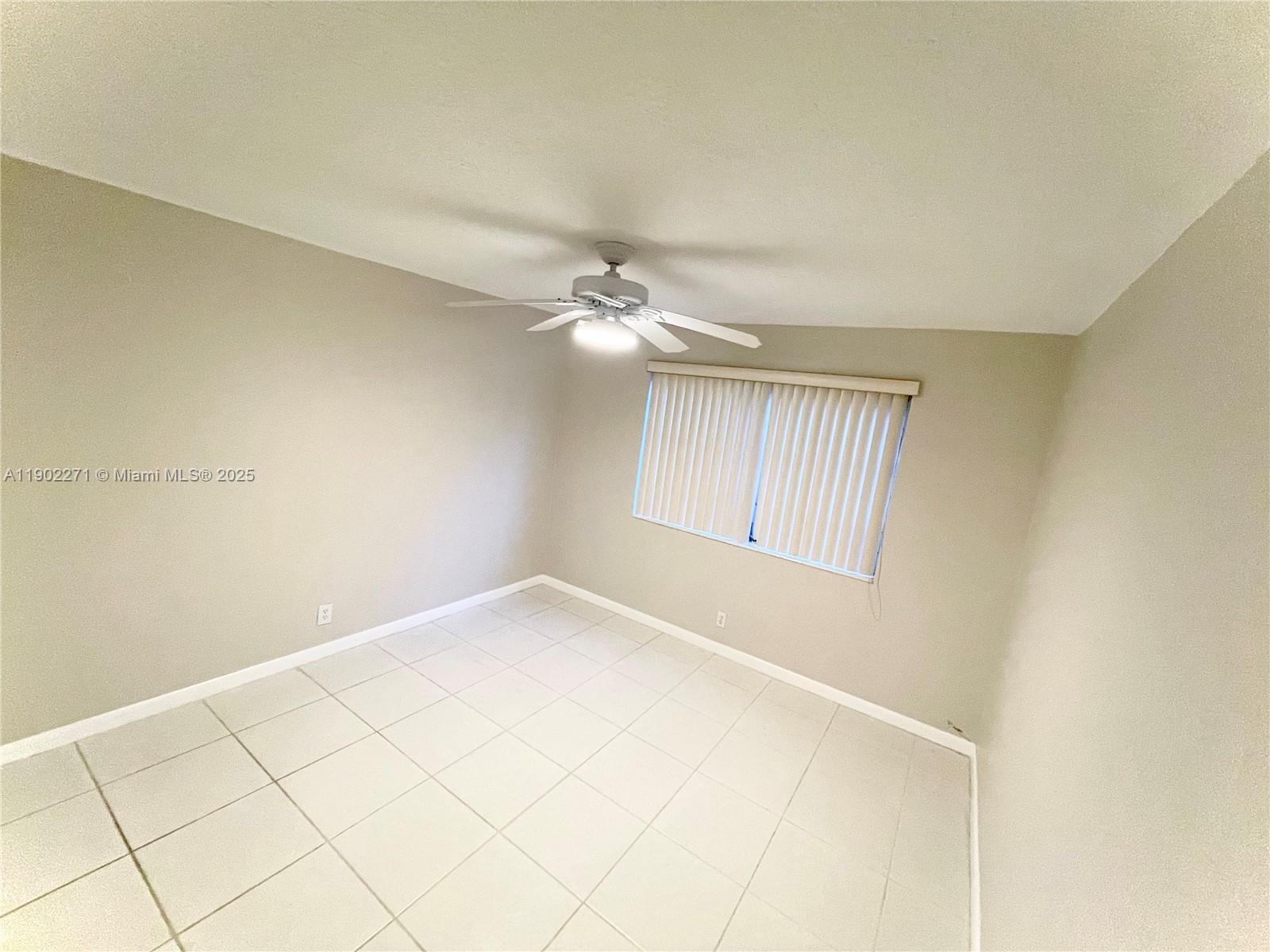 2175 Northeast 56th Street, Unit 105 Fort Lauderdale, FL 33308 - Photo 3 of 26 a view of an empty room with a window