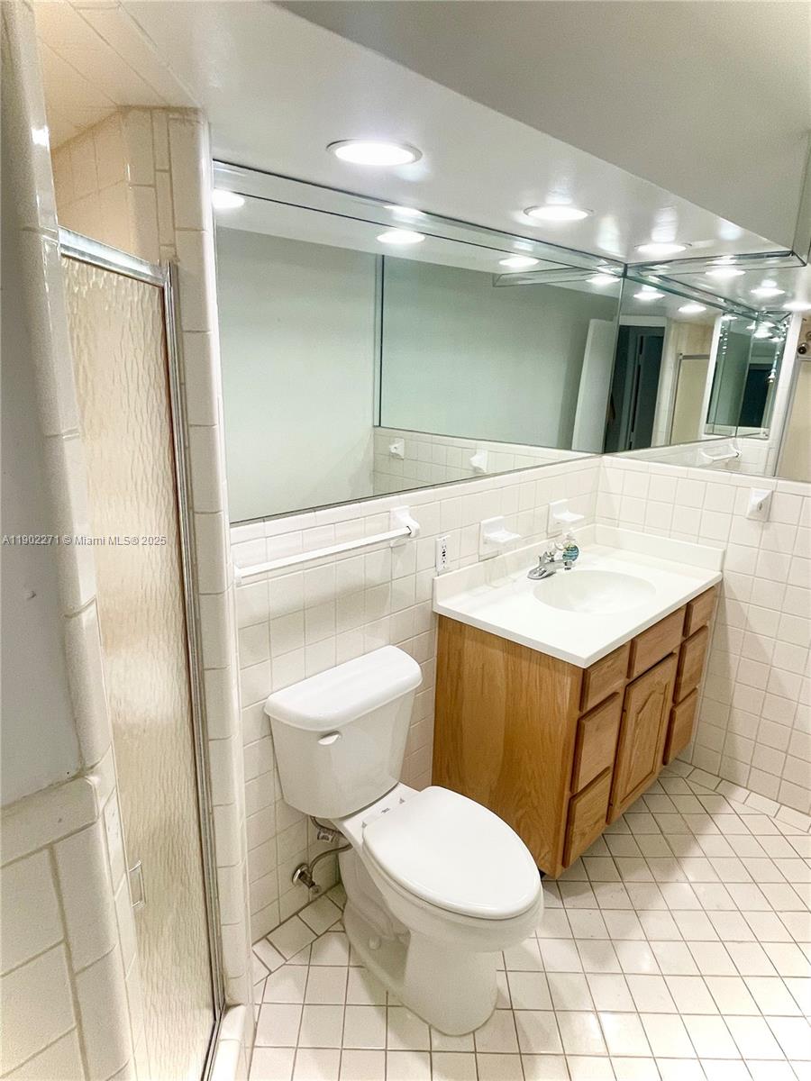 2175 Northeast 56th Street, Unit 105 Fort Lauderdale, FL 33308 - Photo 8 of 26 a bathroom with a sink toilet and mirror