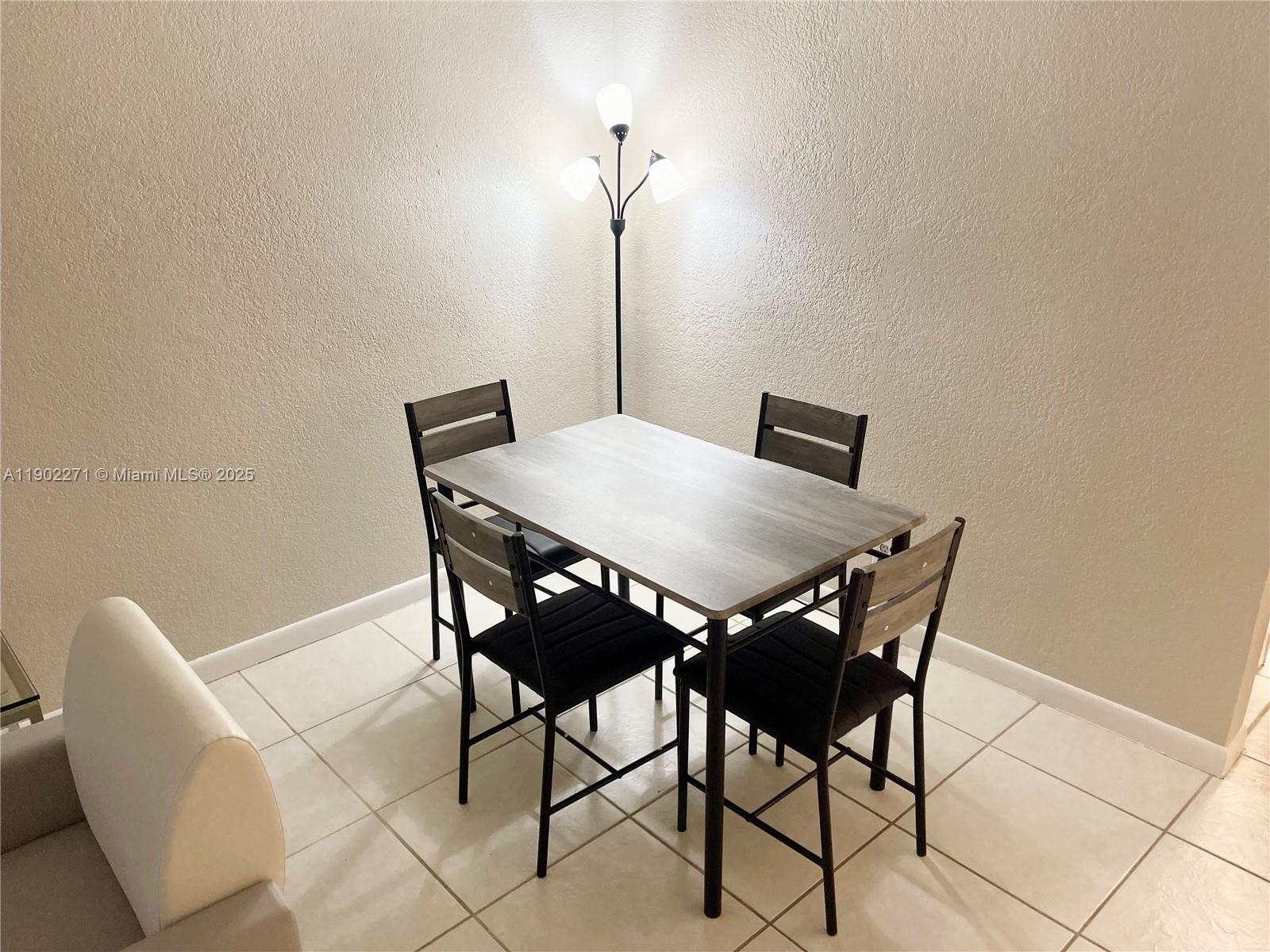 2175 Northeast 56th Street, Unit 105 Fort Lauderdale, FL 33308 - Photo 10 of 26 a view of a dining room with furniture and wooden floor