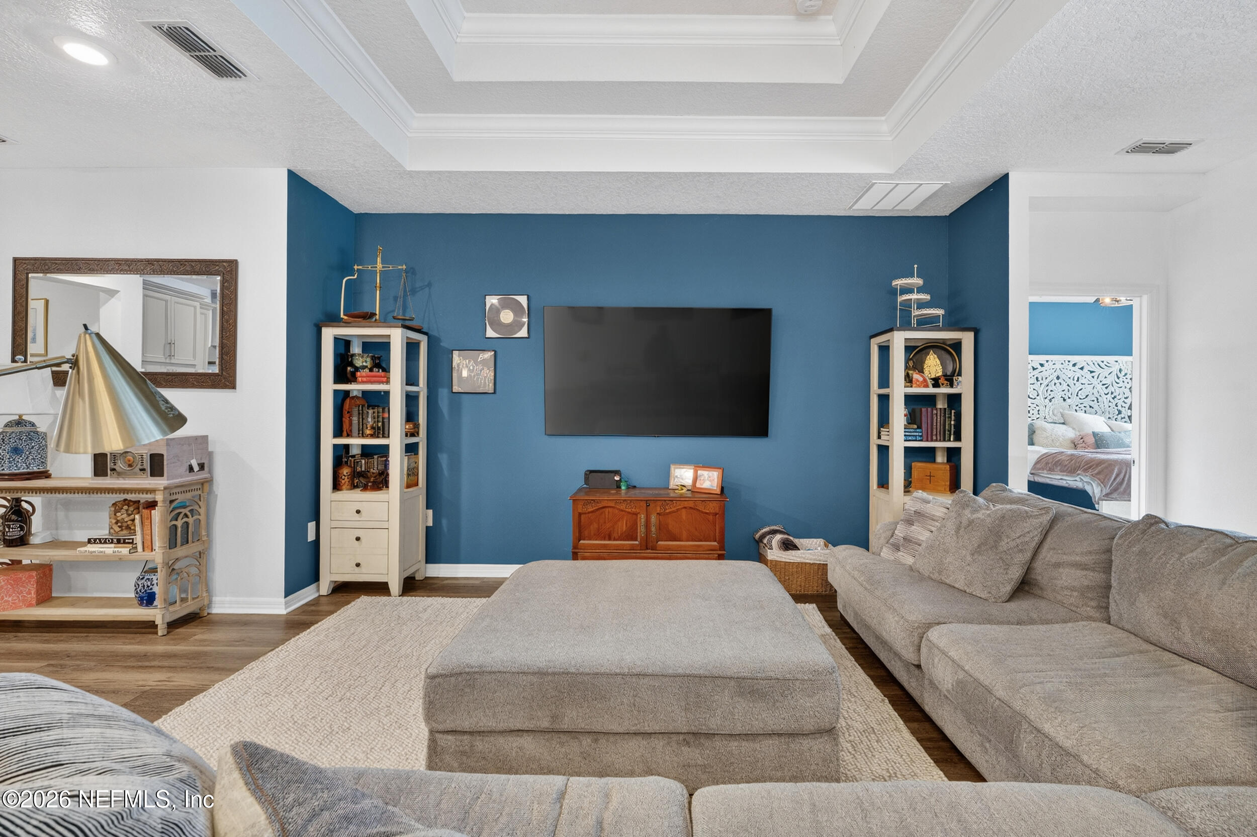 4558 Farmhouse Gate Trail Jacksonville, FL 32226 - Photo 11 of 34 a bedroom with a large bed and a flat screen tv