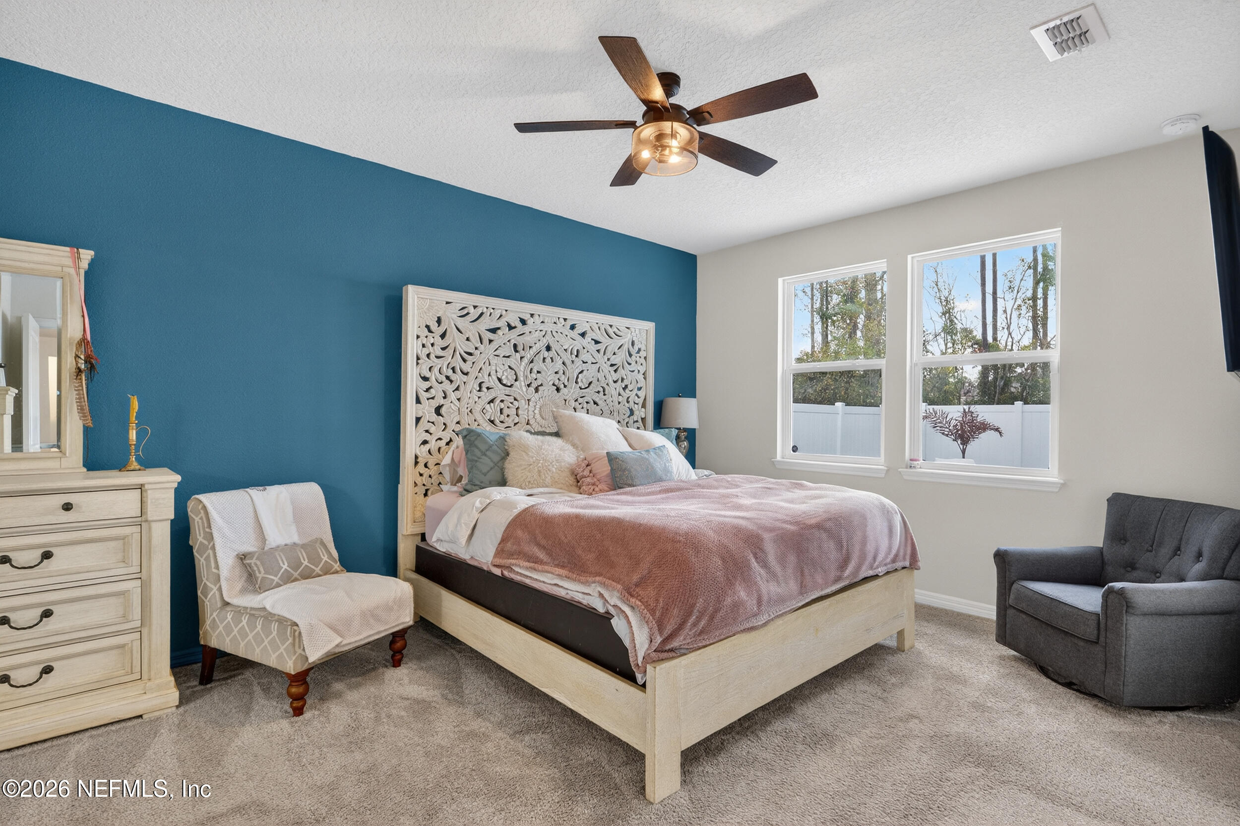 4558 Farmhouse Gate Trail Jacksonville, FL 32226 - Photo 13 of 34 a spacious bedroom with a bed and a couch