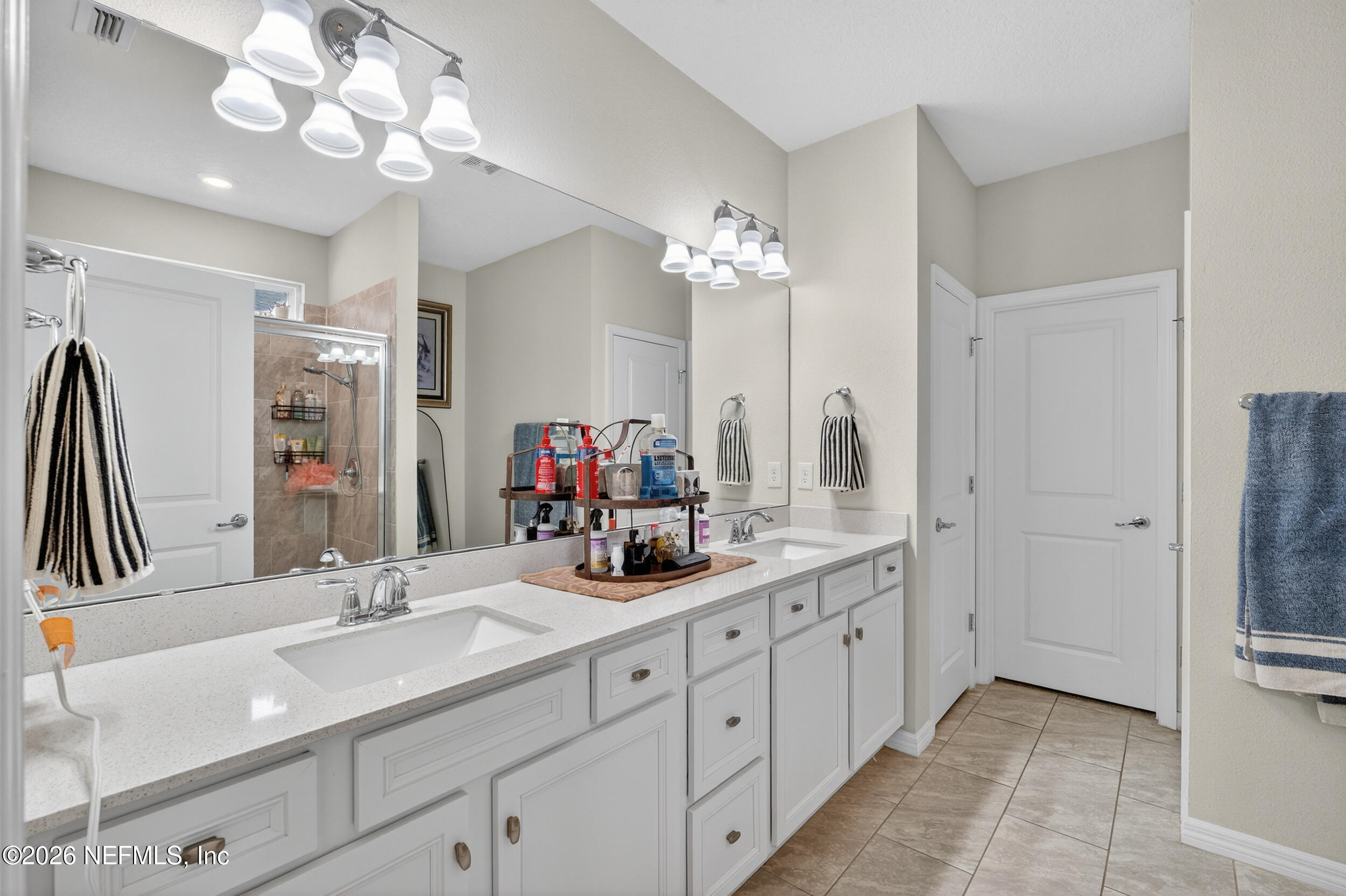 4558 Farmhouse Gate Trail Jacksonville, FL 32226 - Photo 14 of 34 a bathroom with a double vanity sink and a mirror