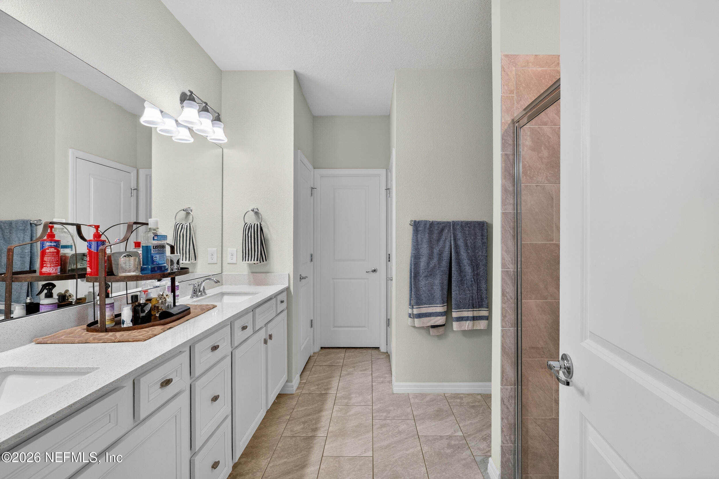4558 Farmhouse Gate Trail Jacksonville, FL 32226 - Photo 15 of 34 a bathroom with a double vanity sink a mirror and shower