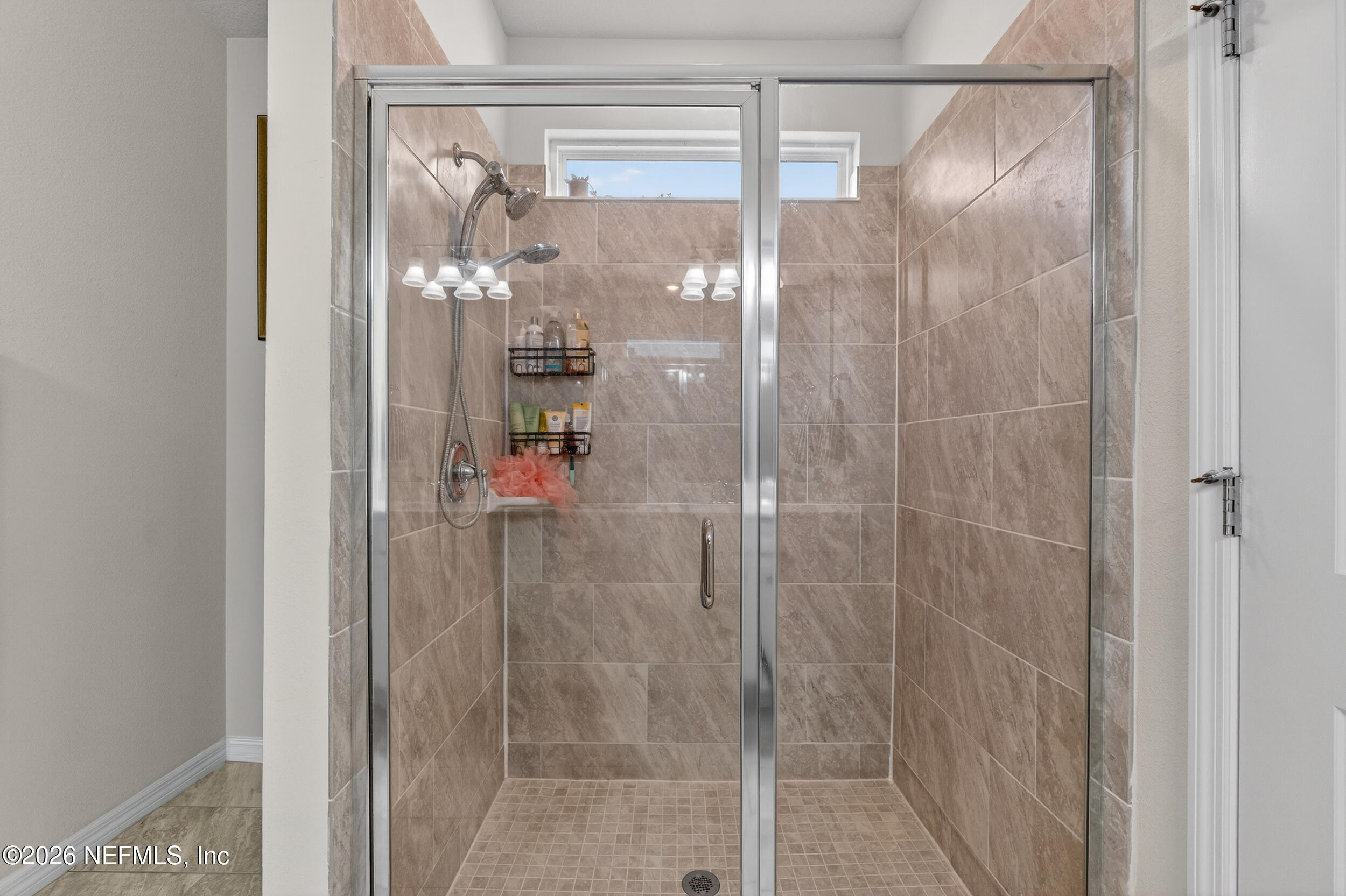 4558 Farmhouse Gate Trail Jacksonville, FL 32226 - Photo 16 of 34 a bathroom with a glass shower door