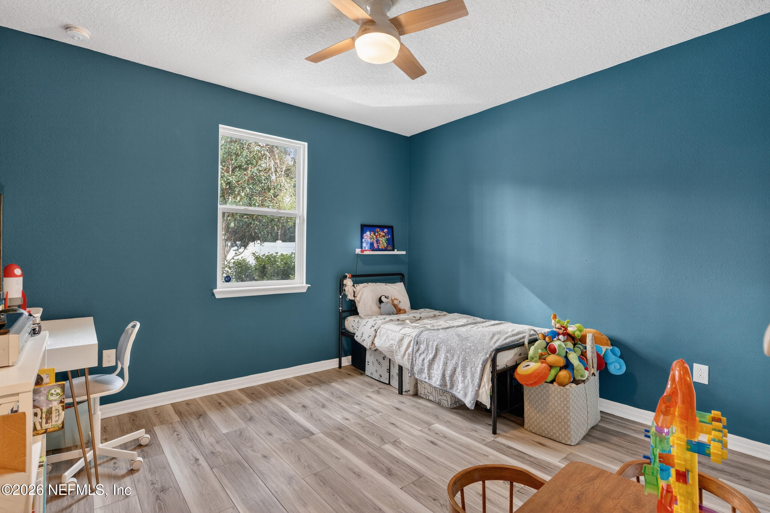 4558 Farmhouse Gate Trail Jacksonville, FL 32226 - Photo 17 of 34 a bedroom with a bed and a chandelier