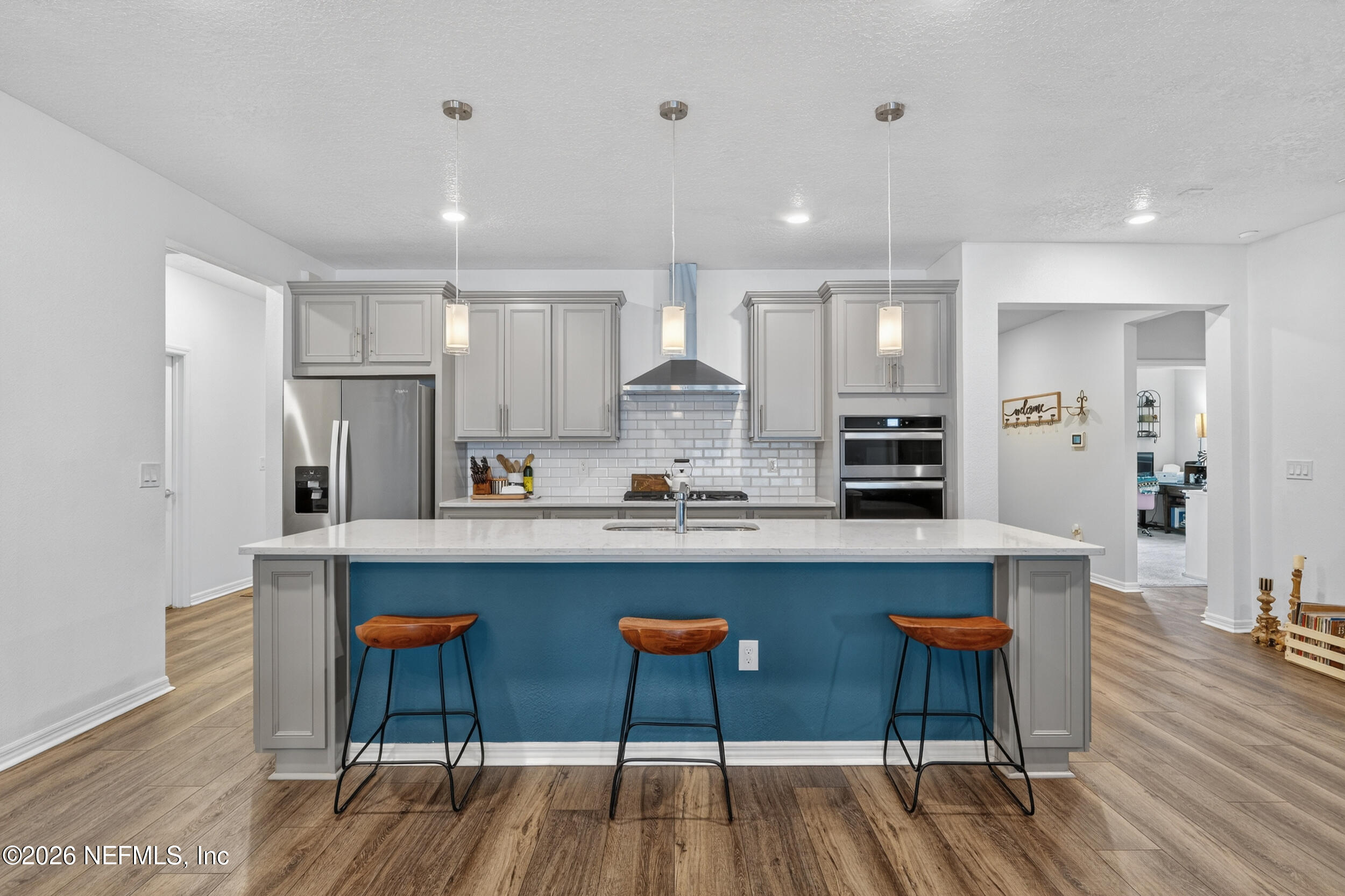 4558 Farmhouse Gate Trail Jacksonville, FL 32226 - Photo 5 of 34 a large kitchen with cabinets chairs and wooden floor