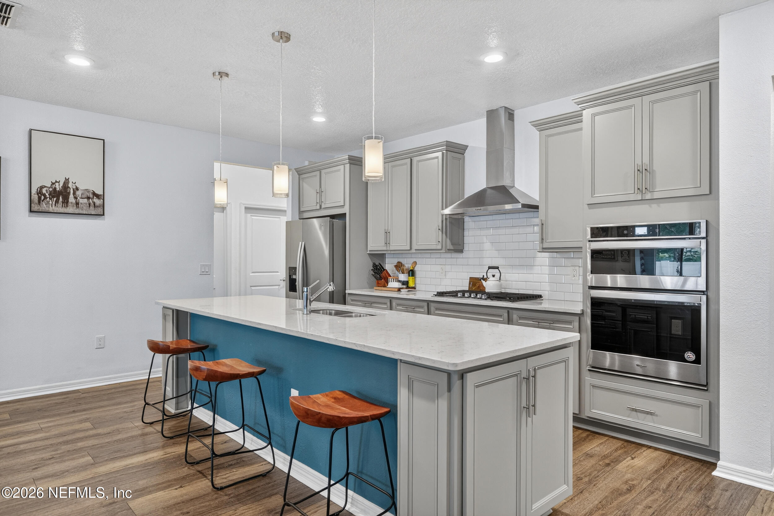 4558 Farmhouse Gate Trail Jacksonville, FL 32226 - Photo 7 of 34 a kitchen with stainless steel appliances white cabinets and a stove top oven