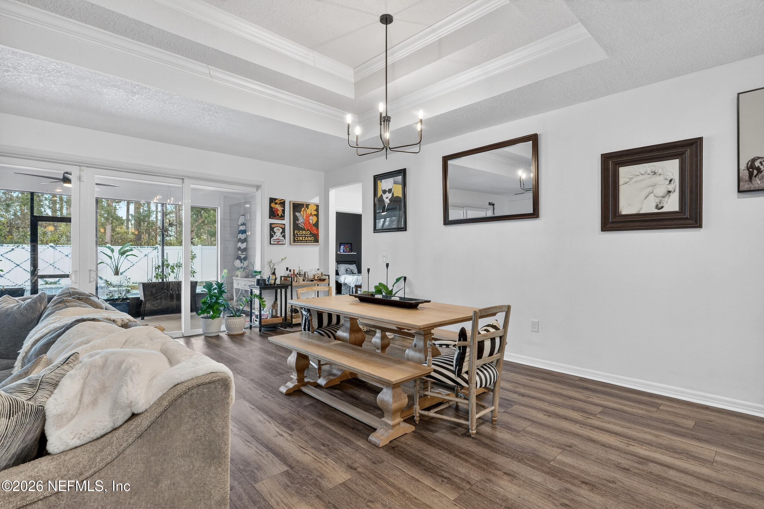 4558 Farmhouse Gate Trail Jacksonville, FL 32226 - Photo 9 of 34 a living room with furniture a window and a chandelier