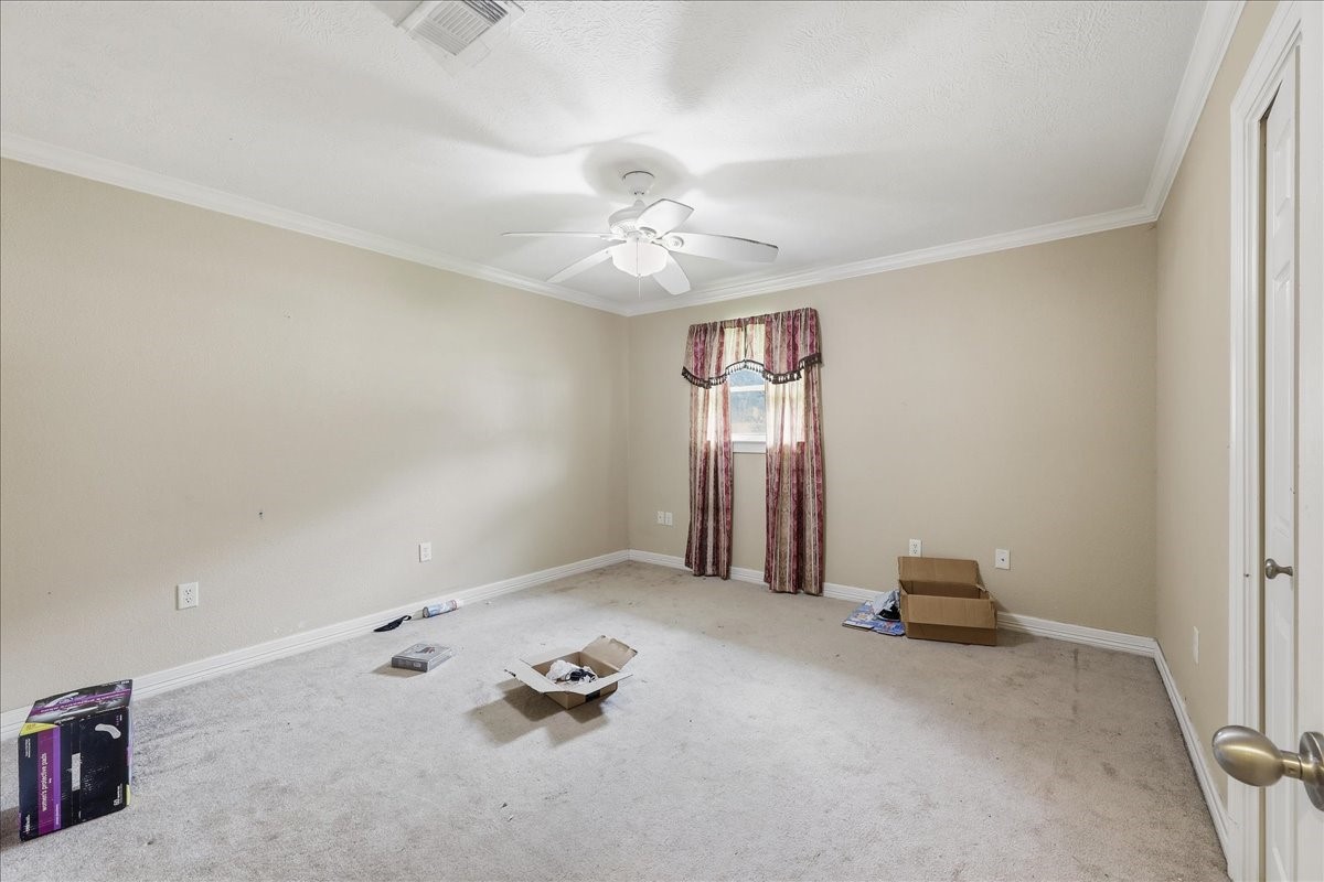 150 Gary Street Bridge City, TX 77611 - Photo 11 of 12 Additional bedroom or flex room with ceiling fan and neutral finishes.