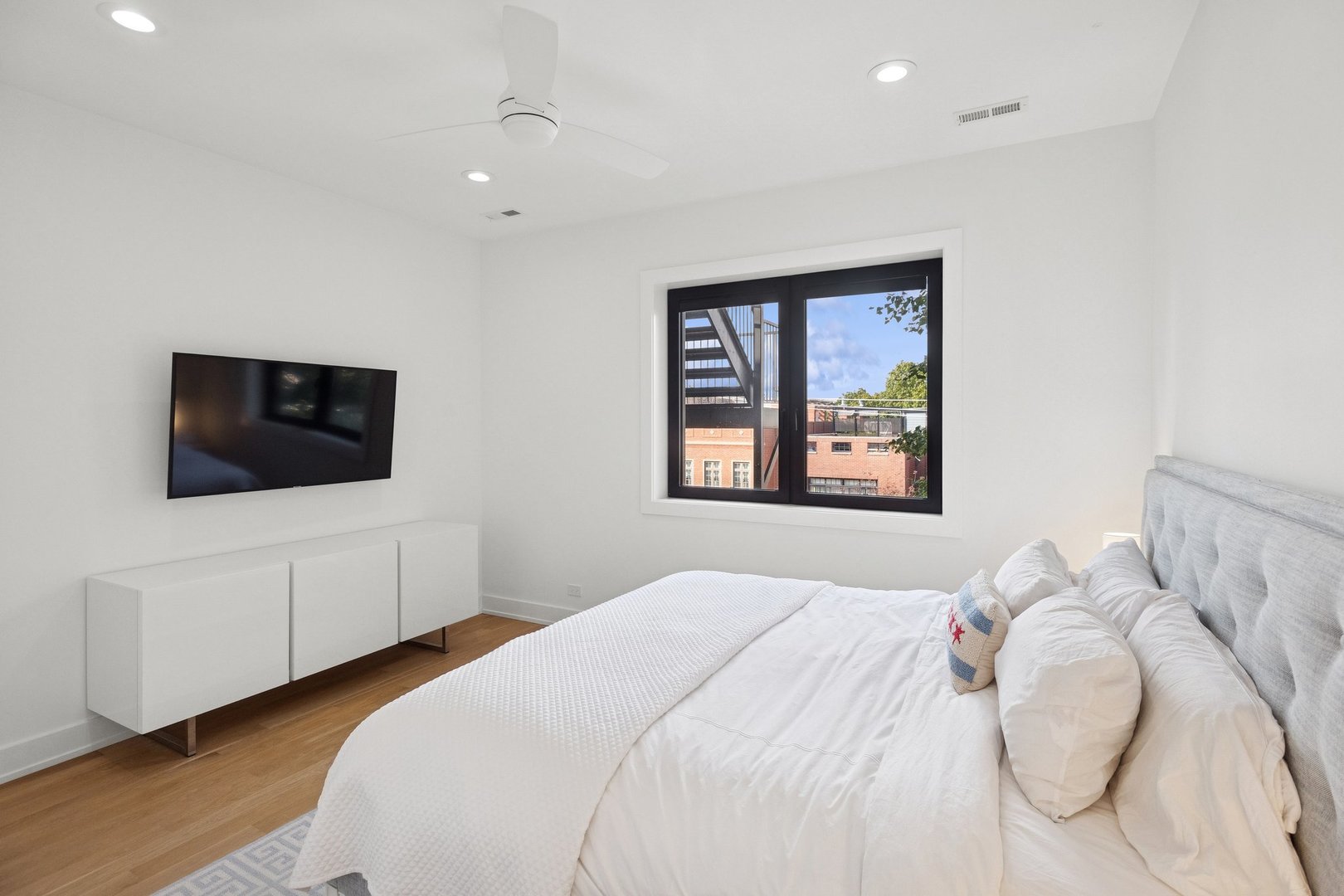 2622 North Racine Avenue, Unit 3 Chicago, IL 60614 - Photo 12 of 28 a bedroom with a large bed and a flat screen tv