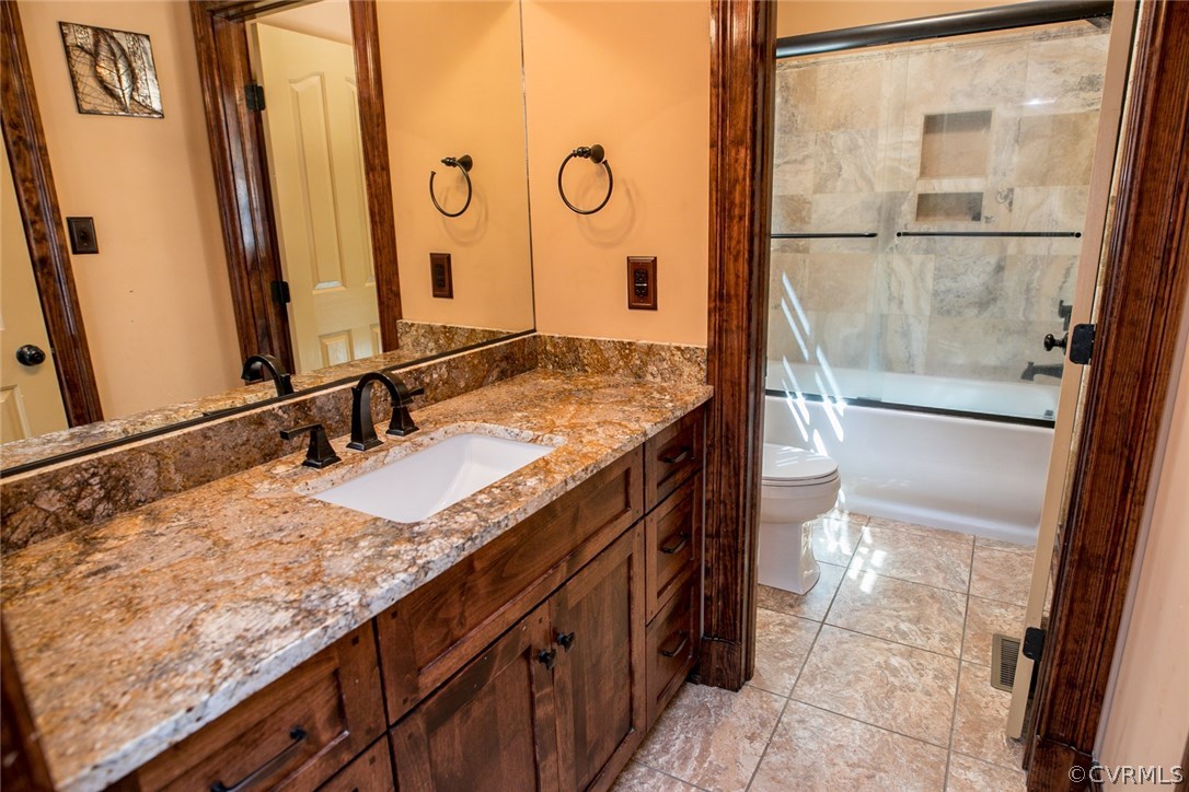 7365 Cedarcrest Road Hanover, VA 23069 - Photo 26 of 50 a bathroom with a granite countertop sink a mirror and a shower