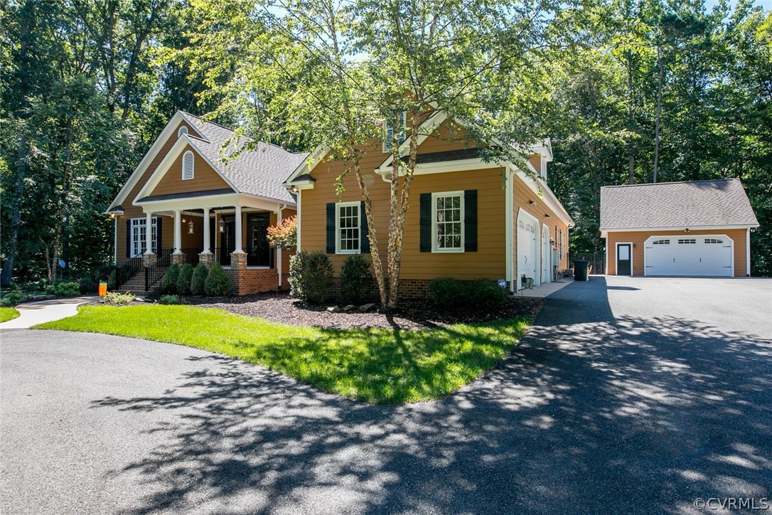 7365 Cedarcrest Road Hanover, VA 23069 - Photo 3 of 50 a front view of a house with a yard and garage