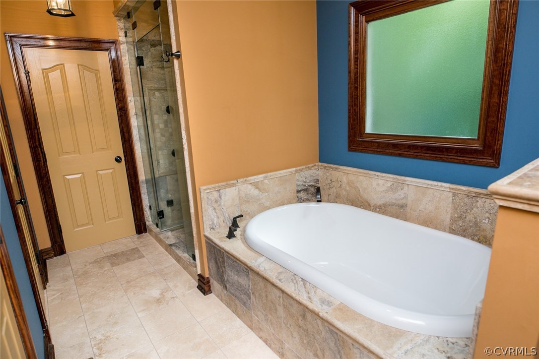 7365 Cedarcrest Road Hanover, VA 23069 - Photo 33 of 50 a bathroom with a bathtub and a shower
