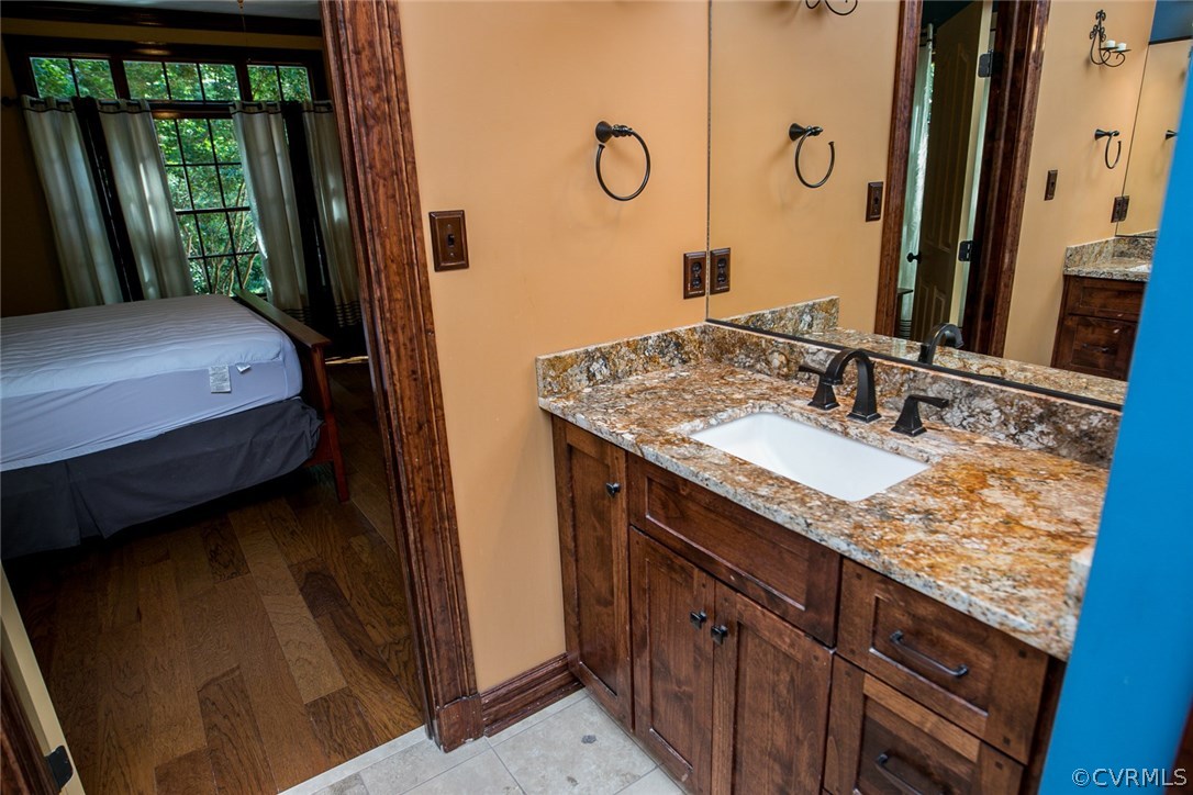 7365 Cedarcrest Road Hanover, VA 23069 - Photo 35 of 50 a en suite bathroom with a granite countertop sink and a mirror