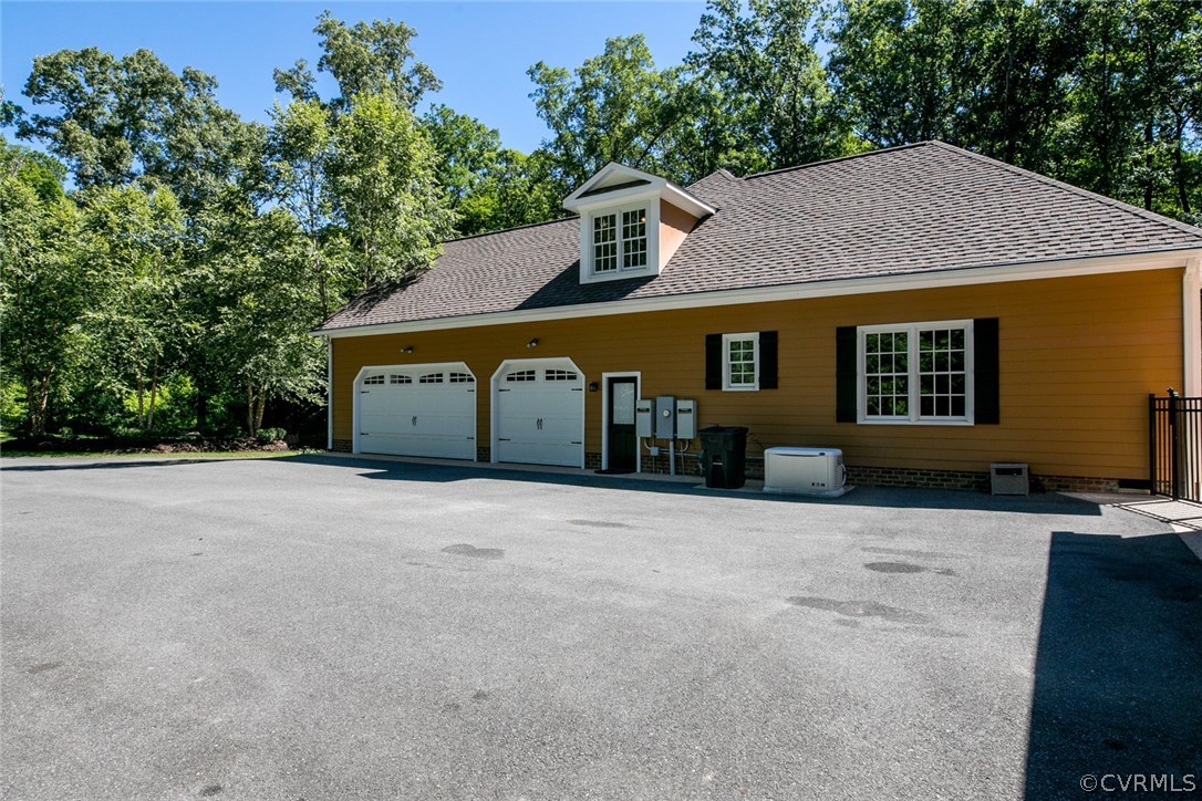 7365 Cedarcrest Road Hanover, VA 23069 - Photo 4 of 50 a front view of a house with a yard and garage