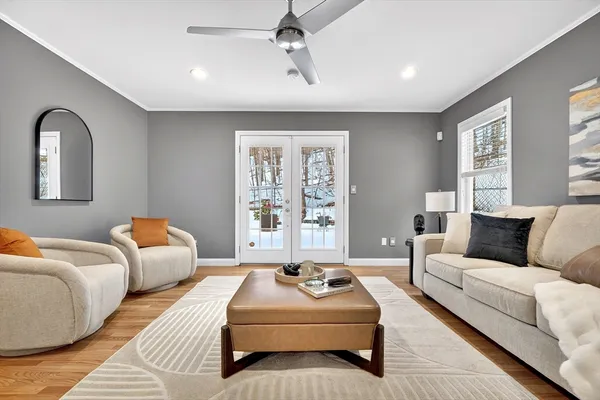 a bedroom with a large bed couch and window