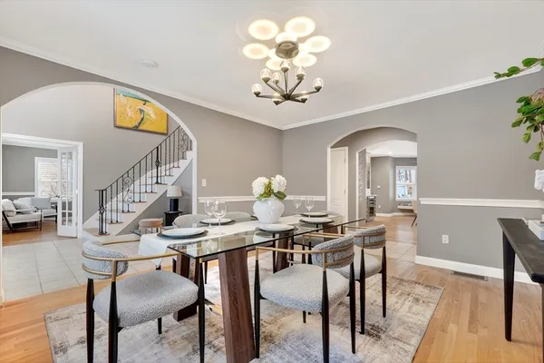 a view of a dining room with furniture and chandelier