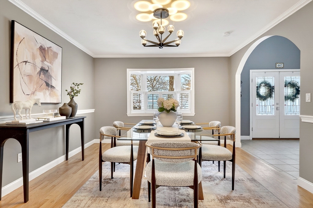 447 Waban Avenue Newton, MA 02462 - Photo 21 of 42 a dining room with furniture a window and a chandelier