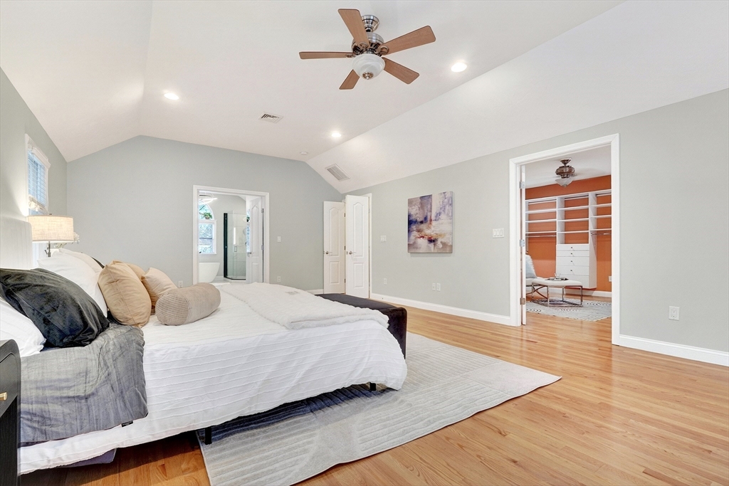 447 Waban Avenue Newton, MA 02462 - Photo 26 of 42 a bedroom with a large bed chandelier and a window
