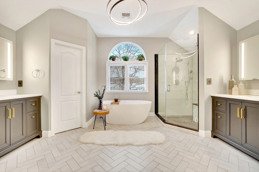 447 Waban Avenue Newton, MA 02462 - Photo 30 of 42 a spacious bathroom with a double vanity sink a mirror and a bathtub