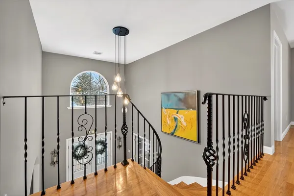 a view of entryway and hall with wooden floor