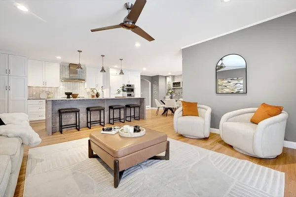 a living room with furniture and a wooden floor