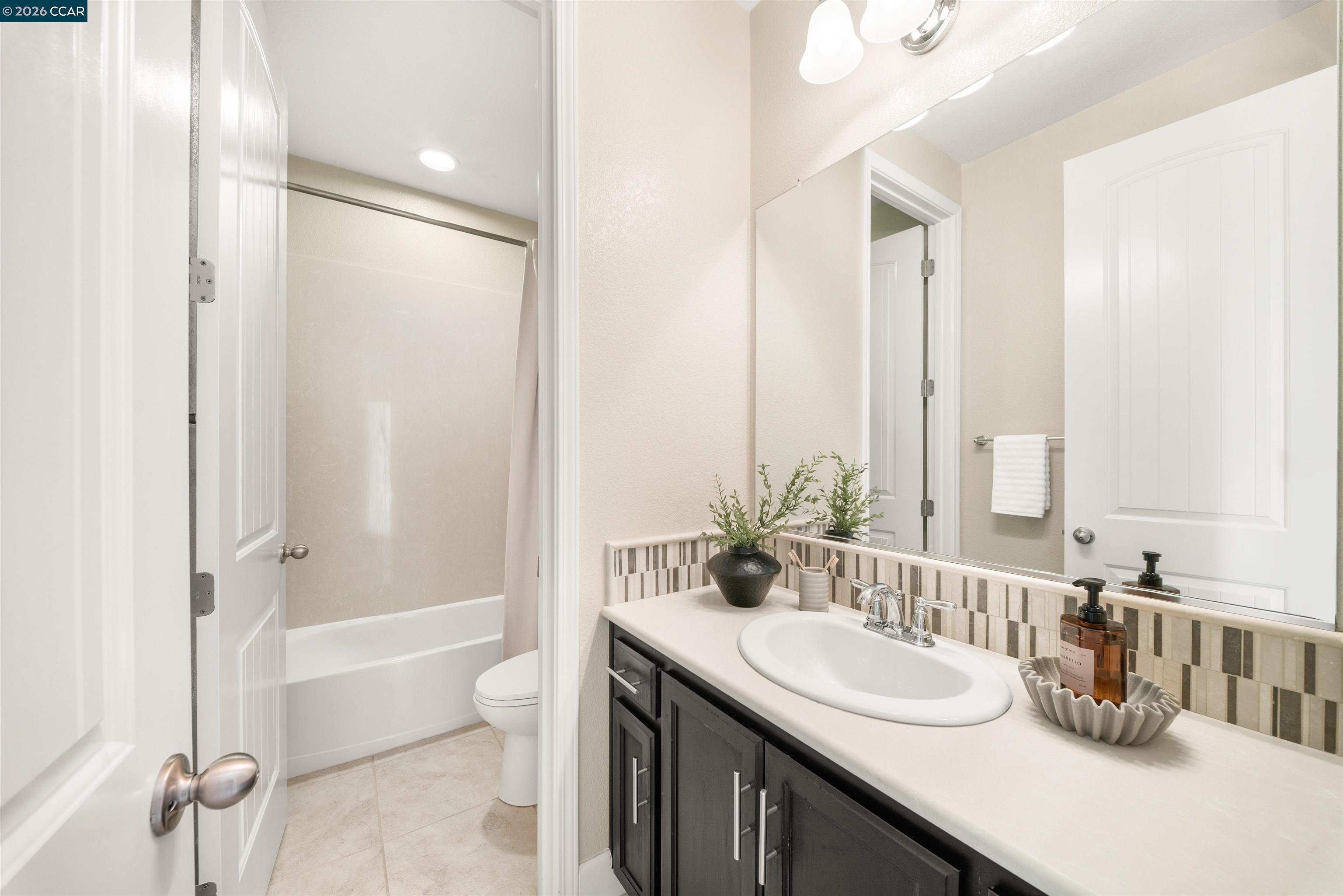2026 Poinsettia Street San Ramon, CA 94582 - Photo 22 of 26 a bathroom with a granite countertop sink and a mirror