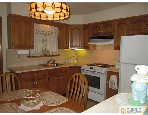 50 Gurley Road Edison, NJ 08817 - Photo 4 of 10 a kitchen with a stove a sink and a microwave
