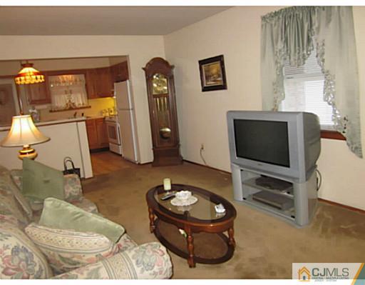 50 Gurley Road Edison, NJ 08817 - Photo 6 of 10 a living room with furniture and a flat screen tv