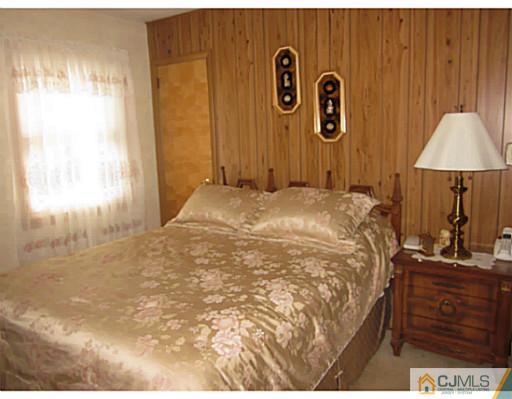 50 Gurley Road Edison, NJ 08817 - Photo 7 of 10 a bed room with a bed and a table