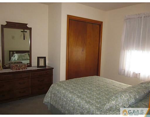 50 Gurley Road Edison, NJ 08817 - Photo 8 of 10 a bedroom with a bed and a dresser