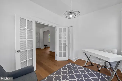 a view of a livingroom with furniture a dinning room and windows