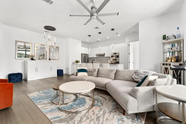 a living room with furniture a rug and a chandelier
