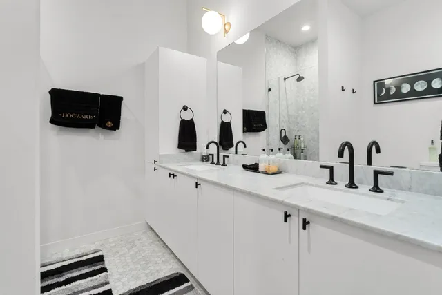 a kitchen with a sink and a flat screen tv
