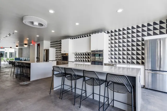 a view of kitchen with furniture and refrigerator