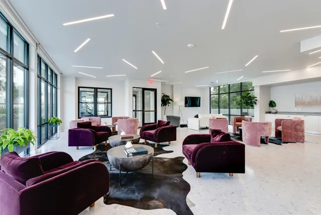 a living room with furniture ceiling fan and a window