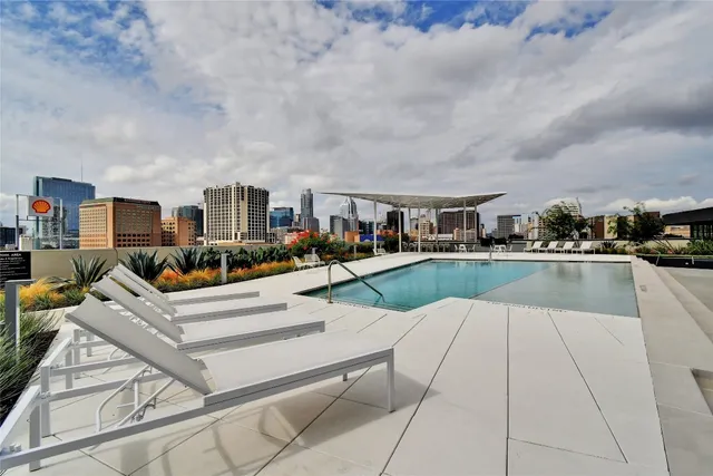 a view of a house with swimming pool and sitting area