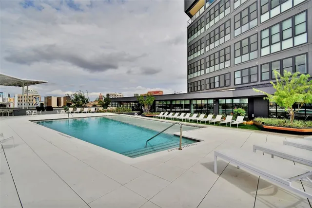 a swimming pool with outdoor seating and yard