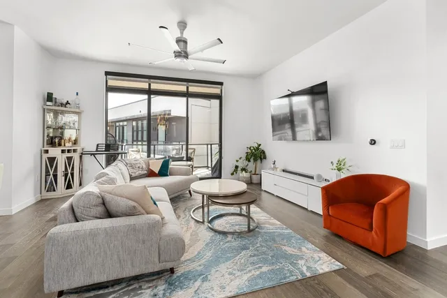 a living room with furniture and a large window