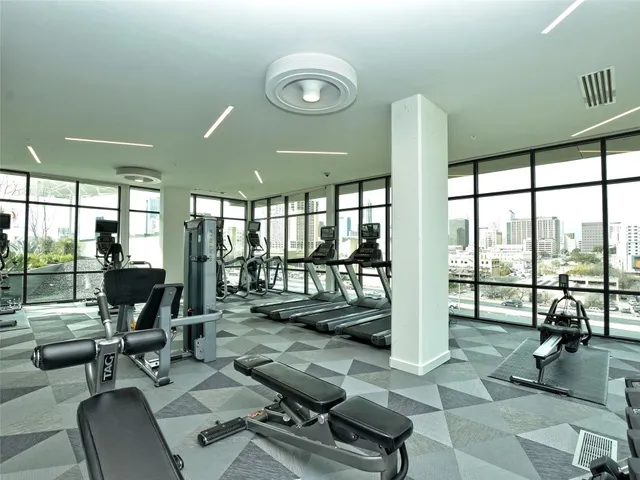 a living room with furniture and large windows
