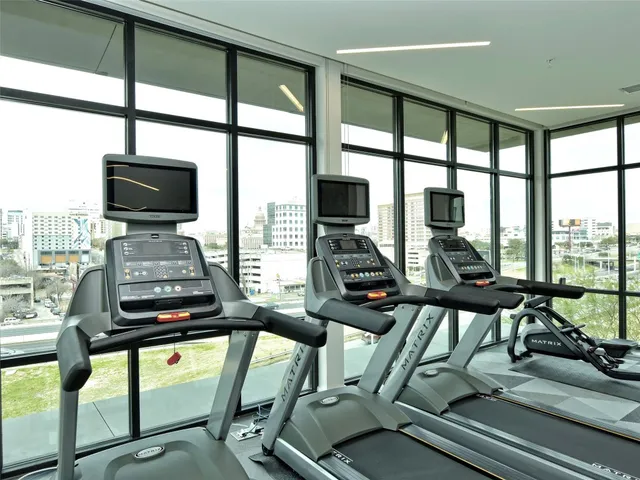 a view of a living room with furniture and floor to ceiling windows