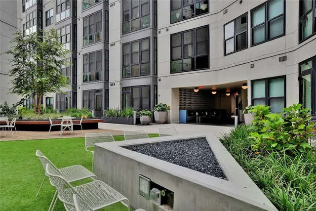 a view of a house with a yard and sitting area
