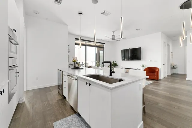 a kitchen with sink stove and refrigerator