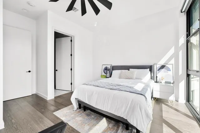 a bedroom with a bed and wooden floor