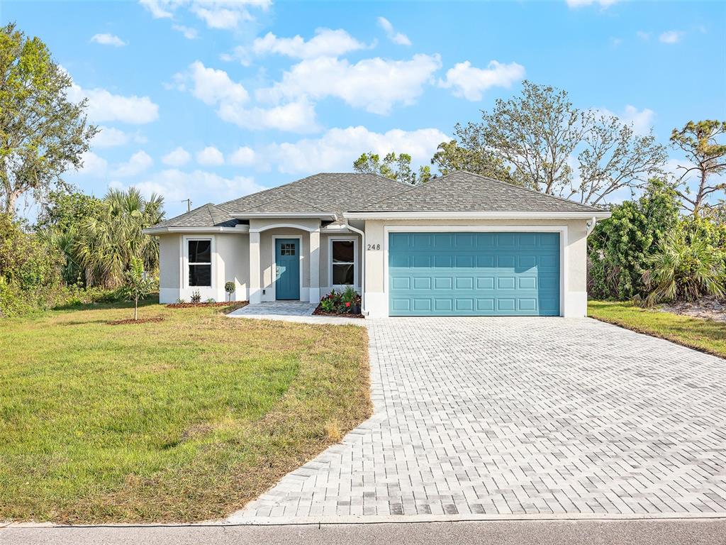 248 Wayne Road Rotonda West, FL 33947 - Photo 1 of 1 a front view of a house with a garden