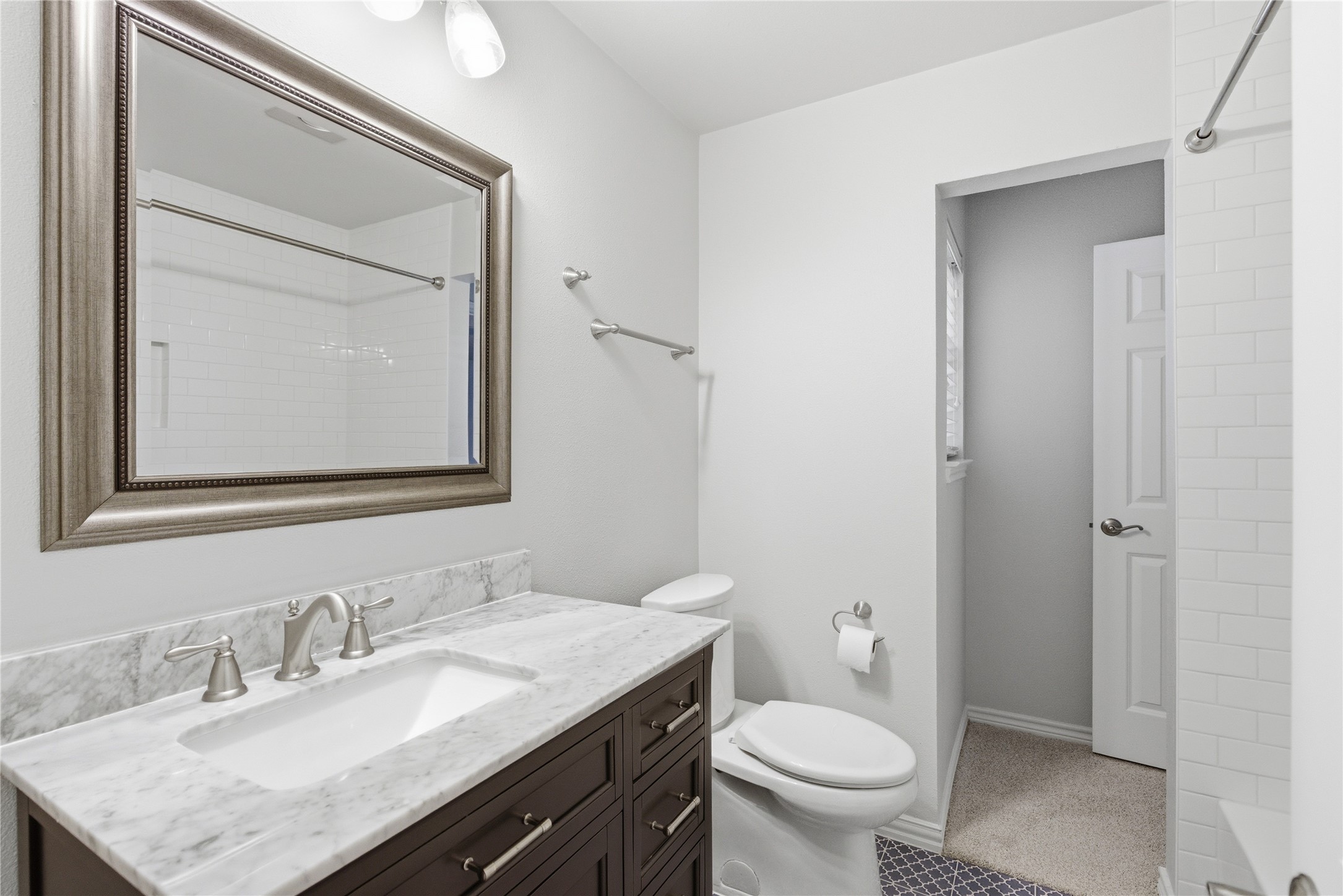 1204 Orlando Road Austin, TX 78733 - Photo 33 of 40 A well-appointed bathroom features a dark wood vanity, pristine marble counters, and a modern rectangular sink.