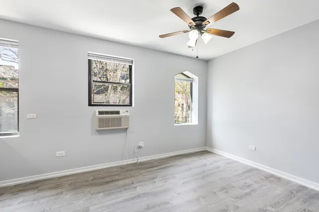 a view of a livingroom with a ceiling fan and window