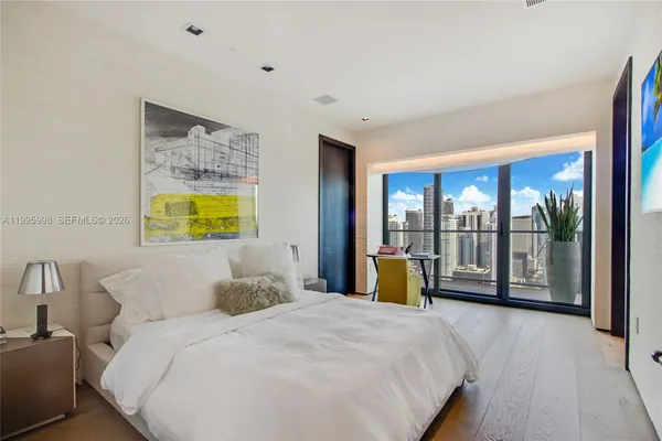 a bedroom with a bed and a large window