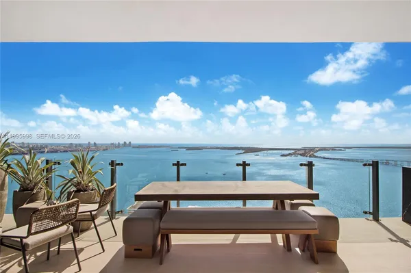 a roof deck with table and chairs