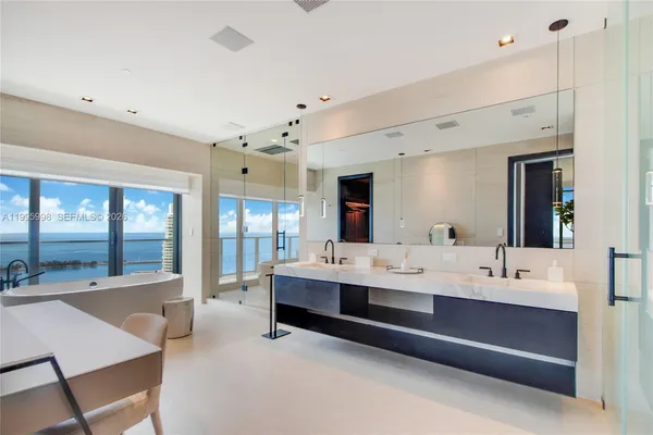 a large white room with a large window and furniture